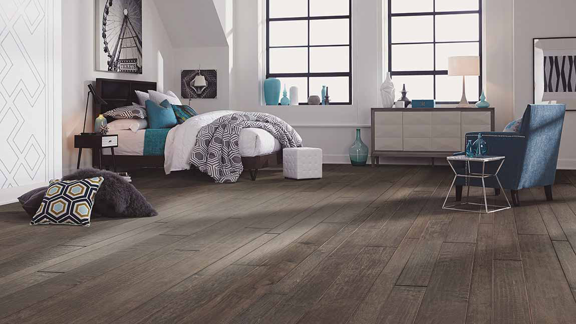 grey hardwood flooring in a spacious bedroom